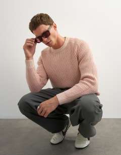 Model wearing Classic fit plaited fisherman knit jumper in pink