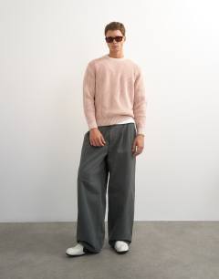 Model wearing Classic fit plaited fisherman knit jumper in pink