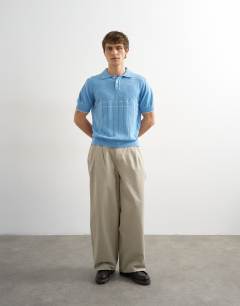 Model wearing Classic fit pointelle knitted polo in light blue