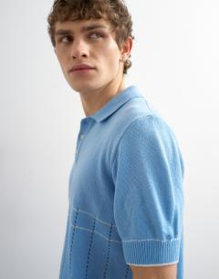 Model wearing Classic fit pointelle knitted polo in light blue
