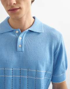 Model wearing Classic fit pointelle knitted polo in light blue