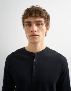 Model wearing Classic fit rib long sleeve henley t-shirt in black