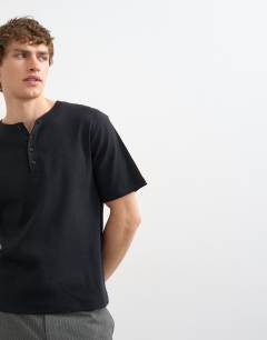 Model wearing Classic fit ribbed henley t-shirt in black