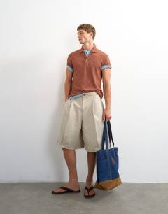 Model wearing Classic fit textured polo in burnt orange
