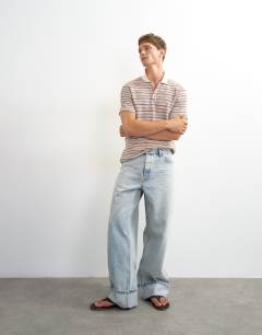 Model wearing Classic fit textured space dye striped polo in multi