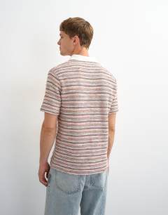 Model wearing Classic fit textured space dye striped polo in multi