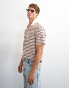 Model wearing Classic fit textured space dye striped polo in multi