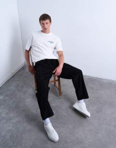Model wearing Cord taper leg trousers in black