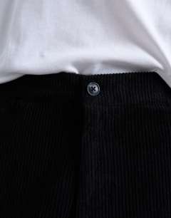 Model wearing Cord taper leg trousers in black
