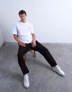 Model wearing Cord taper leg trousers in brown