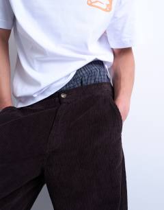 Model wearing Cord taper leg trousers in brown
