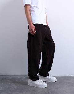 Model wearing Cord taper leg trousers in brown