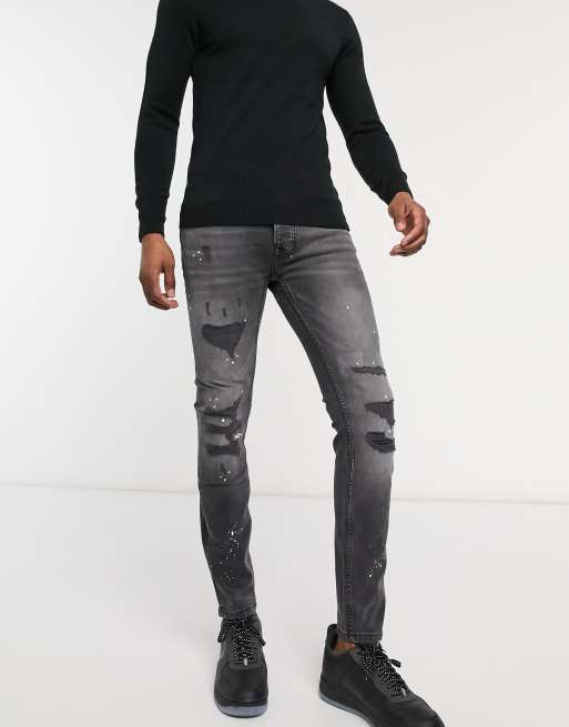 ASOS DESIGN super skinny jeans in washed black with paint splatter