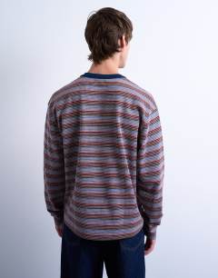 Model wearing Crop fit long sleeve t-shirt in multi stripe