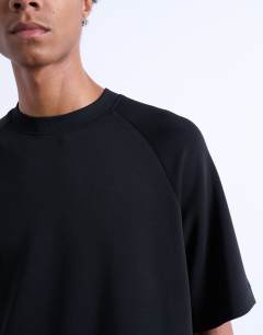 Model wearing Crop fit raglan tee in black