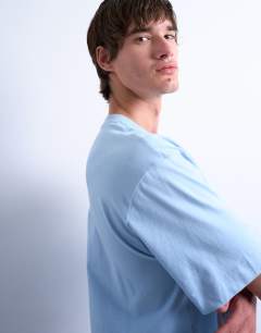 Model wearing Crop fit t-shirt in light blue