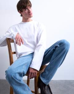 Model wearing Cropped fit long sleeve t-shirt in white