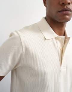 Model wearing Cropped fit ribbed polo shirt in cream 
