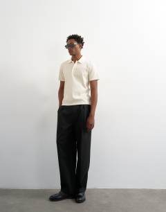 Model wearing Cropped fit ribbed polo shirt in cream 