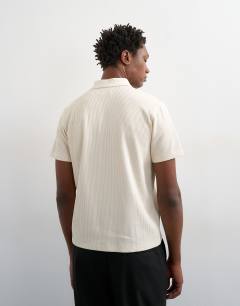 Model wearing Cropped fit ribbed polo shirt in cream 