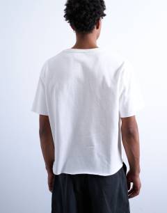 Model wearing Cropped fit slub raw edge tee in white