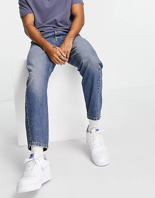Topman taper curved leg jeans in mid wash blue