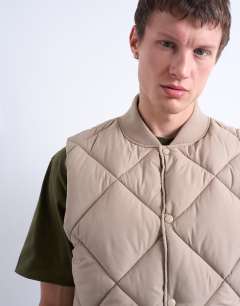 Model wearing Diamond quilt gilet in stone