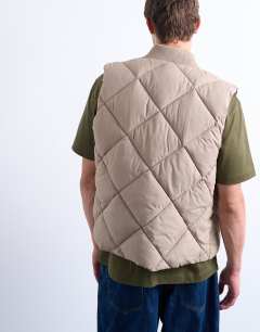 Model wearing Diamond quilt gilet in stone