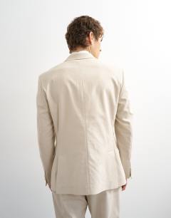 Model wearing Double breasted linen rich blazer in stone