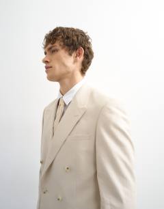 Model wearing Double breasted linen rich blazer in stone