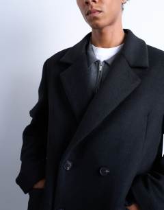 Model wearing Double breasted wool blend overcoat in black