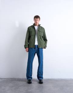 Model wearing Double pocket funnel neck canvas jacket in green