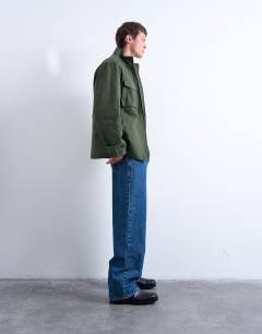 Model wearing Double pocket funnel neck canvas jacket in green