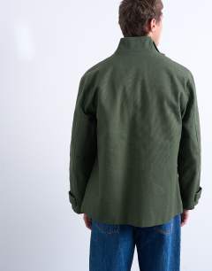Model wearing Double pocket funnel neck canvas jacket in green