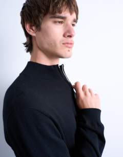 Model wearing Essential 1/4 zip funnel with wool in black
