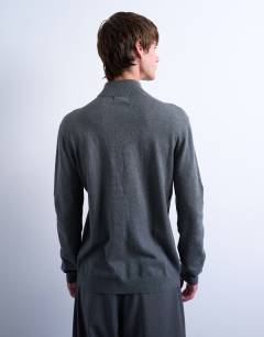 Model wearing Essential 1/4 zip funnel with wool in charcoal