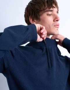 Model wearing Essential 1/4 zip funnel with wool in navy