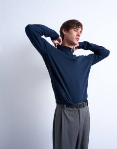 Model wearing Essential 1/4 zip funnel with wool in navy