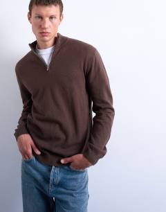 Model wearing Essential knitted 1/4 zip funnel in brown