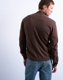 Model wearing Essential knitted 1/4 zip funnel in brown