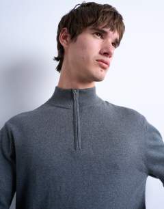 Model wearing Essential knitted 1/4 zip funnel in charcoal