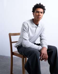 Model wearing Essential knitted button polo in light grey