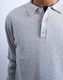 Model wearing Essential knitted button polo in light grey