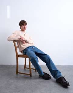 Model wearing Essential knitted button polo in stone