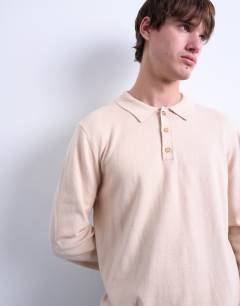 Model wearing Essential knitted button polo in stone