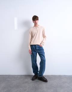 Model wearing Essential knitted button polo in stone