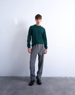 Model wearing Essential knitted crew neck in dark green