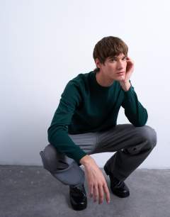 Model wearing Essential knitted crew neck in dark green