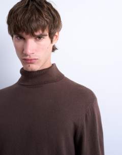 Model wearing Essential knitted roll neck in brown