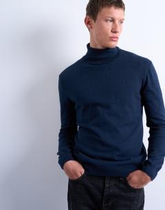 Model wearing Essential knitted roll neck in navy